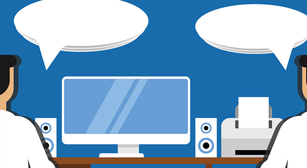 An illustration of two people with speech bubbles sitting at a desk with a computer and printer, representing an IT consultation.