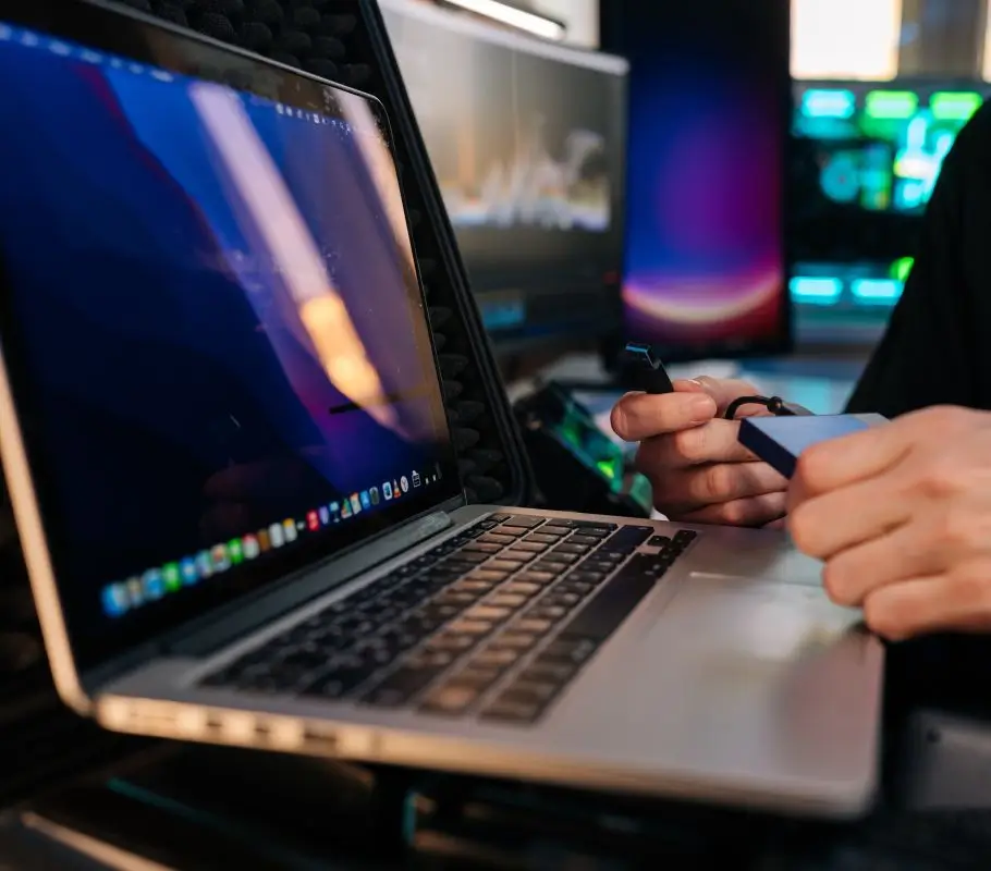 A technician at New Ross PC Repairs safely transferring recovered files from a laptop to a secure portable SSD.